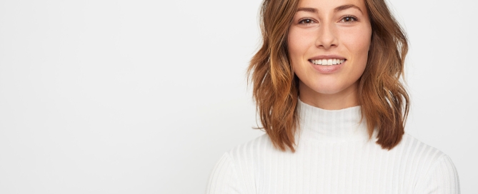 young Woman in white sweater receiving Studio Portraits in Brooklyn